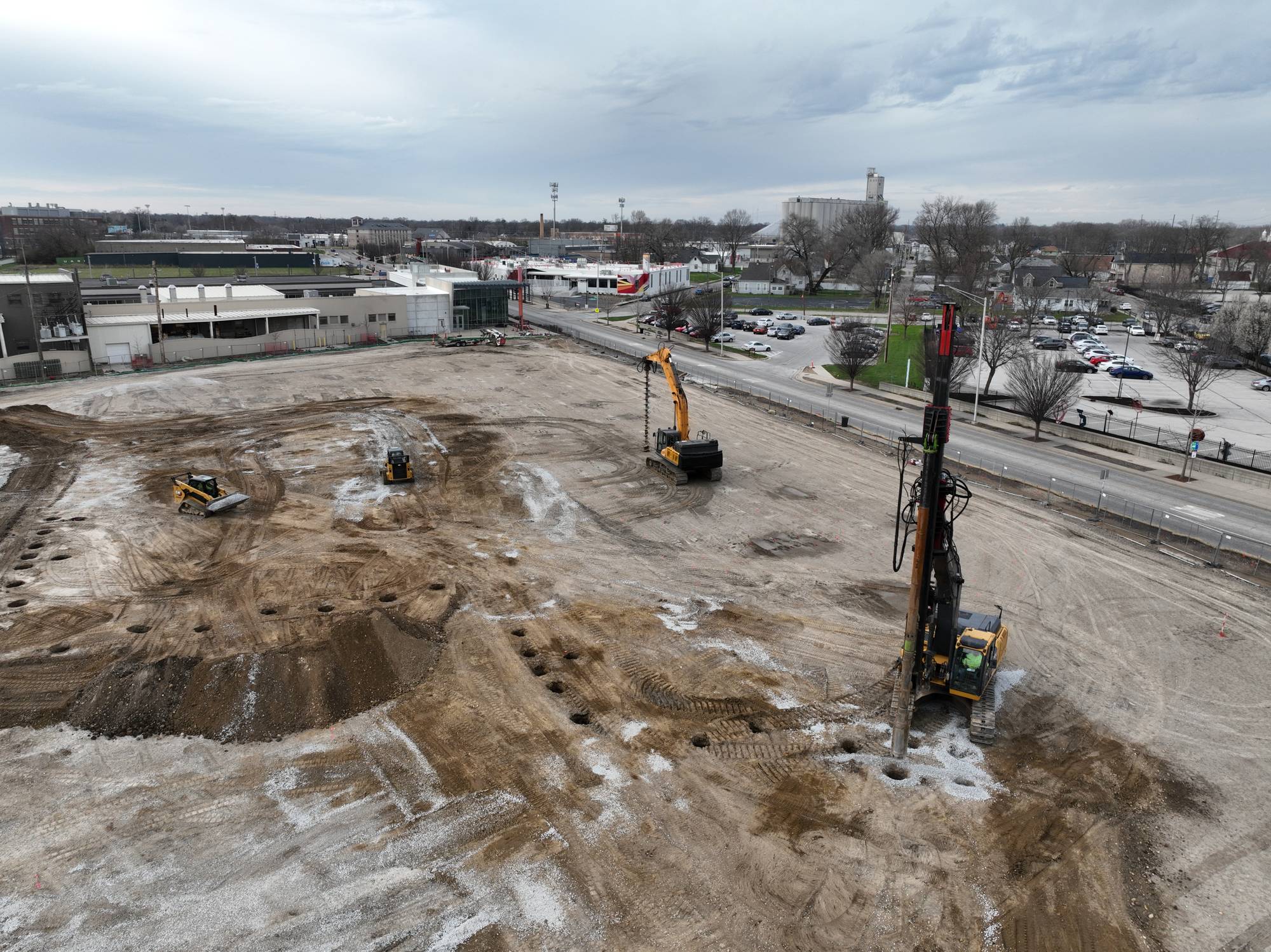 Aerial view of the IU Launch Accelerator ground-improvement site in Indianapolis, Indiana, with a vibratory drilling rig and excavator installing stone columns.