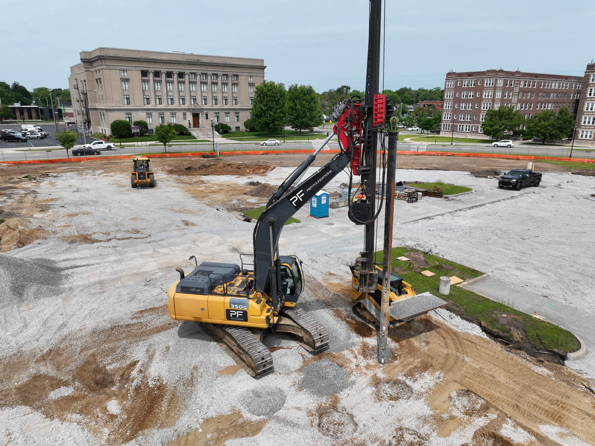 Aerial view of a Pier Foundations parking-structure ground-improvement site, with the PF-branded rig and completed stone columns across the prepared pad.